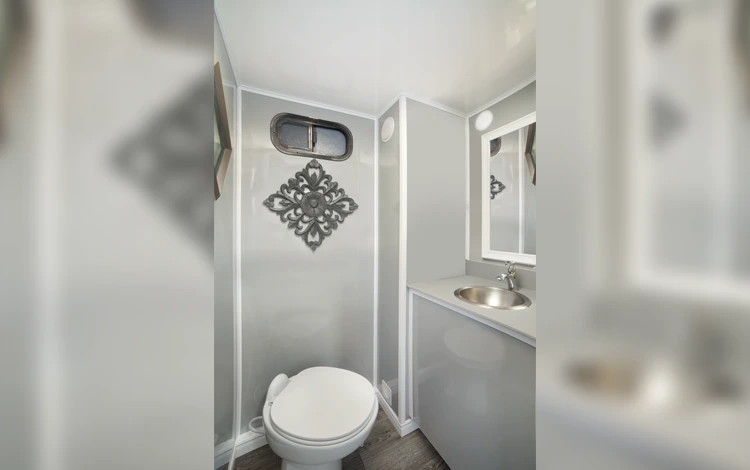 Luxury restroom trailers and hand wash station setup by DFW Toilets at an outdoor wedding in Arlington